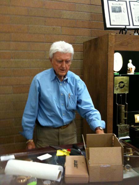 Bob Selene unloading items and stocking display case as his wife Arlene supervises!